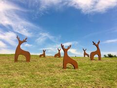 Sika deer sculpture on the turf behind the visitor center