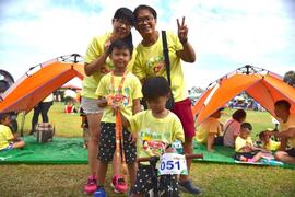 Children finish the race and get finishing prize with parents