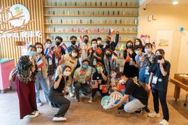 Group photo at Cadozea Story House with their national flags